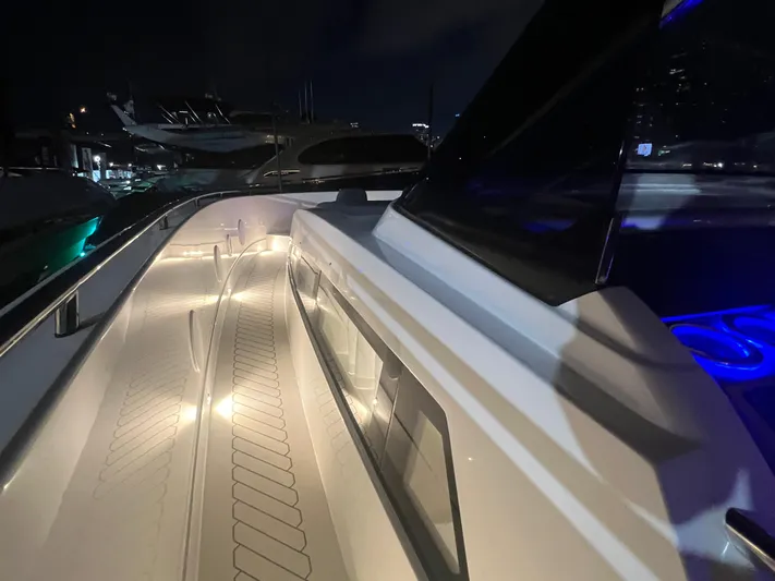  Yacht Photos Pics 2023 Canados 493 Gladiator yacht deck illuminated at night, showcasing sleek design and modern features.