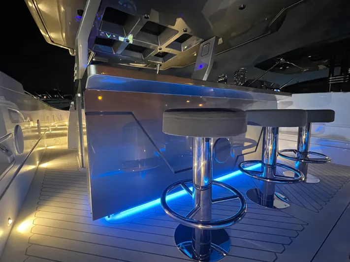  Yacht Photos Pics 2023 Canados 493 Gladiator yacht interior with illuminated bar and modern stools.