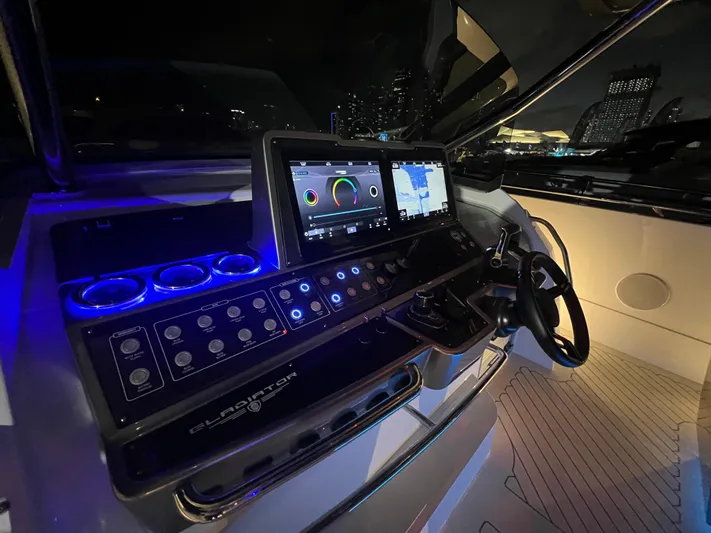  Yacht Photos Pics 2023 Canados 493 Gladiator yacht cockpit with illuminated control panel and navigation screens.