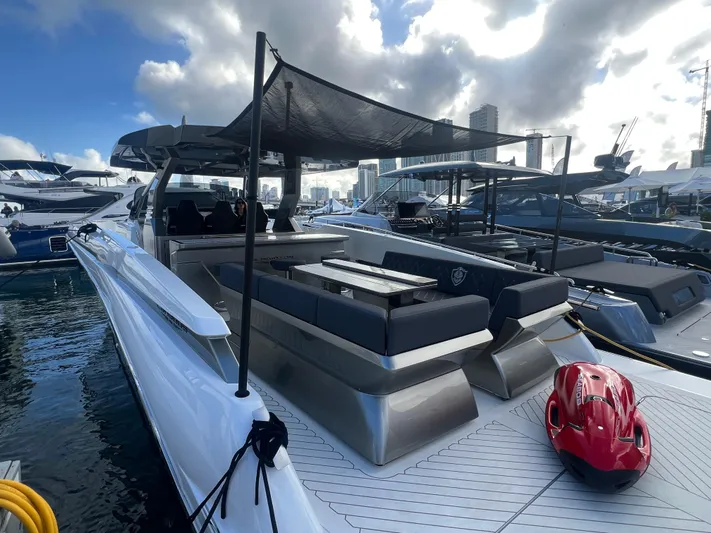  Yacht Photos Pics 2023 Canados 493 Gladiator yacht docked, featuring sleek design and spacious deck area.