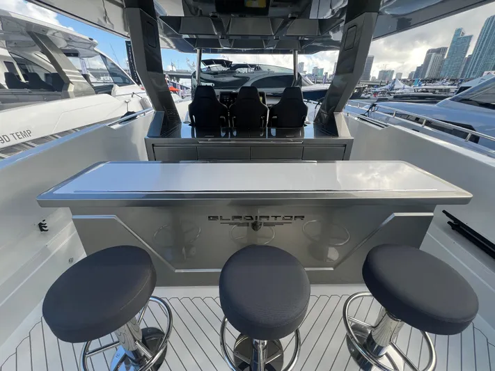  Yacht Photos Pics 2023 Canados 493 Gladiator yacht interior with sleek bar and modern seating.