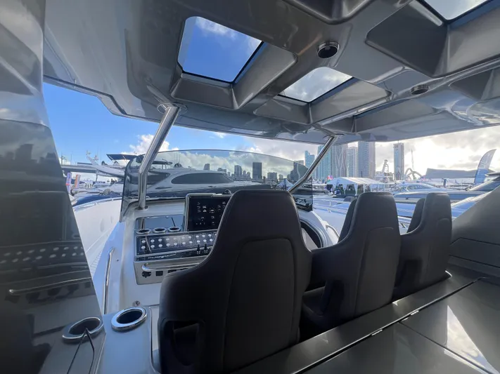  Yacht Photos Pics 2023 Canados 493 Gladiator yacht cockpit with modern controls and panoramic city skyline view.