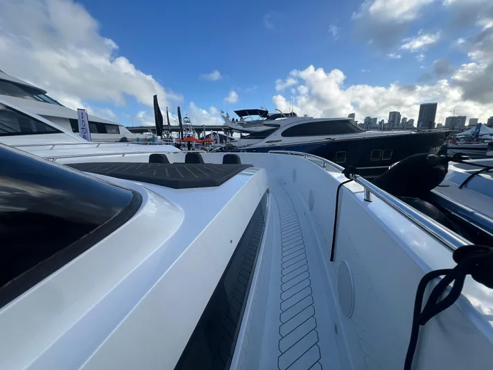  Yacht Photos Pics 2023 Canados 493 Gladiator yacht docked at marina under blue sky.