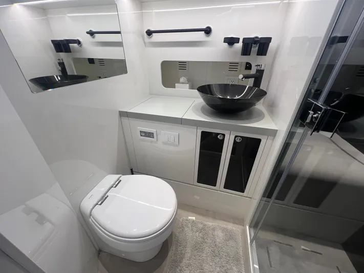  Yacht Photos Pics Modern bathroom in 2023 Canados 493 Gladiator yacht with sleek fixtures and elegant design.