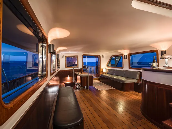 La Fenice Yacht Photos Pics Interior of a 1962 Laurent Giles yacht with wooden floors and elegant lighting.