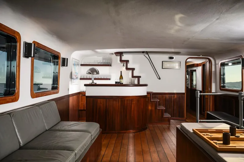 La Fenice Yacht Photos Pics Interior of a 1962 Laurent Giles yacht with wooden floors and elegant furnishings.