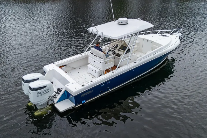  Yacht Photos Pics 2003 Intrepid 32 boat with dual Suzuki engines on calm water.