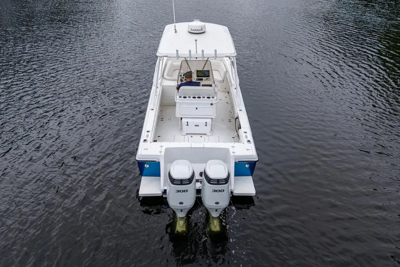  Yacht Photos Pics 2003 Intrepid 32 boat with dual engines on calm water, aerial view.