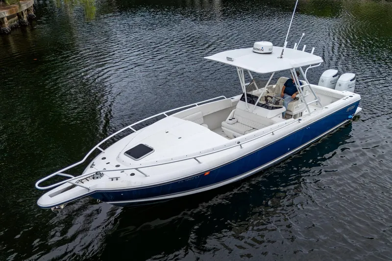  Yacht Photos Pics 2003 Intrepid 32 boat with blue hull and twin engines on calm water.