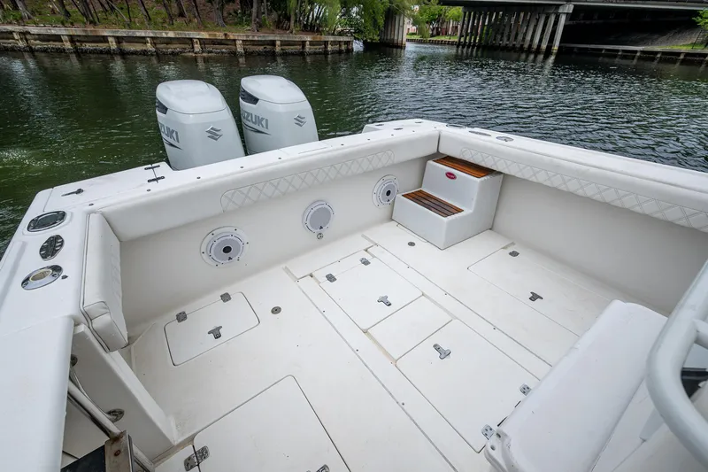  Yacht Photos Pics 2003 Intrepid 32 boat interior with dual Suzuki engines, docked near a bridge.