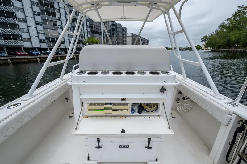  Yacht Photos Pics 2003 Intrepid 32 boat interior with fishing rod holders and storage, docked near waterfront buildings.
