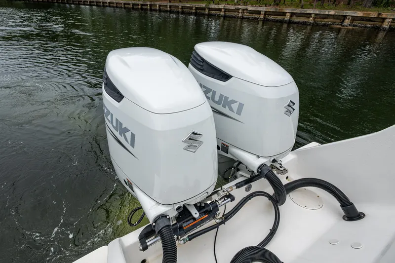  Yacht Photos Pics Twin Suzuki outboard motors on a 2003 Intrepid 32 boat in water.