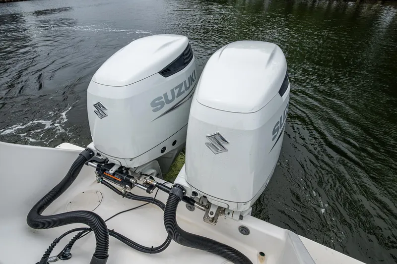  Yacht Photos Pics Twin Suzuki outboard motors on a 2003 Intrepid 32 boat in water.