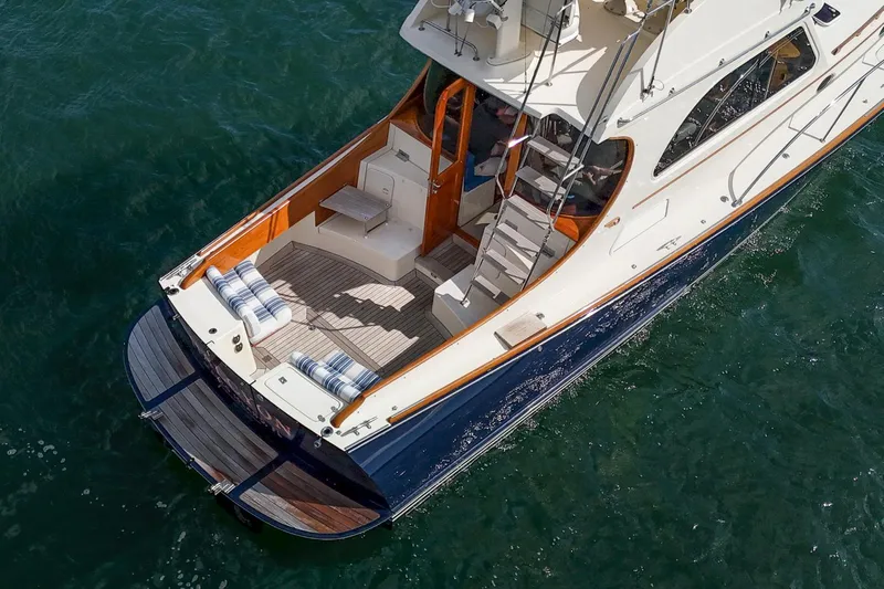 Halcyon Yacht Photos Pics 2006 Hinckley Talaria 44 FB yacht on water, featuring elegant deck and seating area.