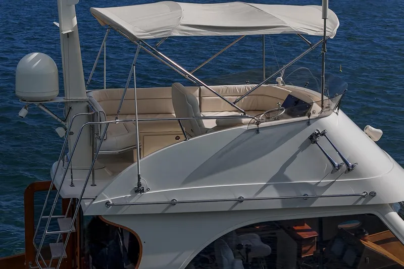 Halcyon Yacht Photos Pics 2006 Hinckley Talaria 44 FB yacht with flybridge and canopy on open water.