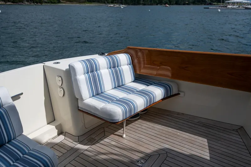 Halcyon Yacht Photos Pics Hinckley Talaria 44 FB 2006 boat with striped seating and wooden accents on deck.