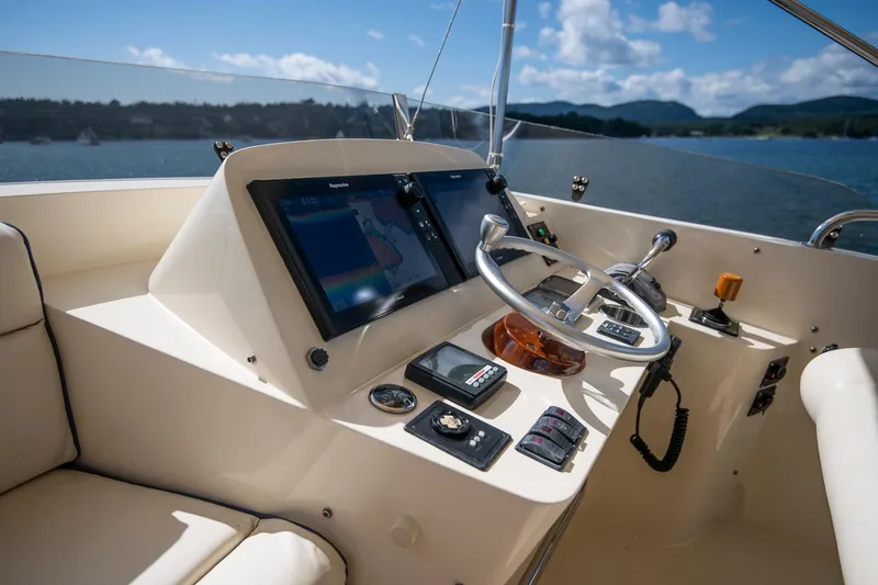 Halcyon Yacht Photos Pics Helm of 2006 Hinckley Talaria 44 FB yacht with navigation screens and steering wheel.
