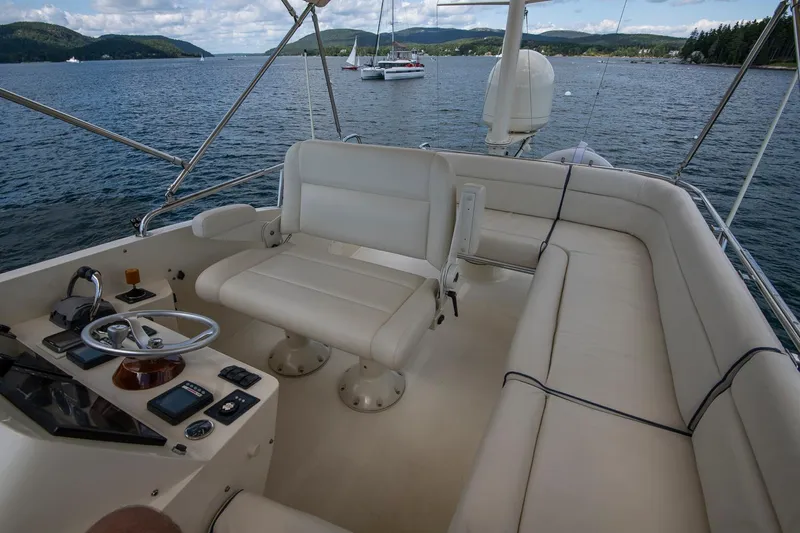 Halcyon Yacht Photos Pics 2006 Hinckley Talaria 44 FB yacht interior with helm and seating, on calm water.