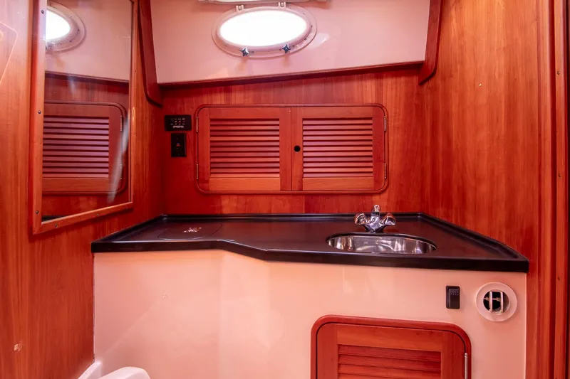 Halcyon Yacht Photos Pics 2006 Hinckley Talaria 44 FB yacht bathroom with wood paneling and sink.