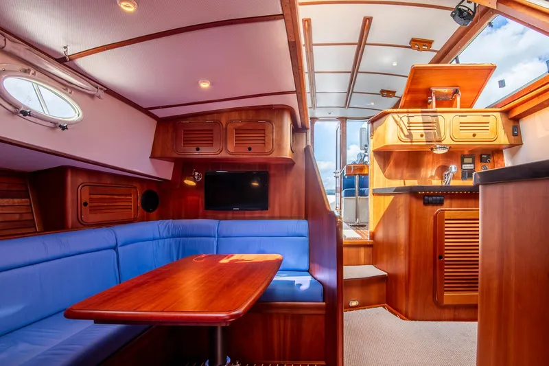 Halcyon Yacht Photos Pics 2006 Hinckley Talaria 44 FB yacht interior with wood finish and blue seating.