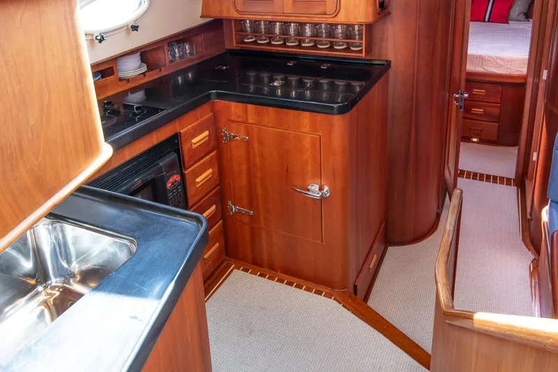 Halcyon Yacht Photos Pics Luxurious 2006 Hinckley Talaria 44 FB yacht interior with elegant wood cabinetry and modern kitchen amenities.