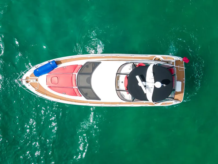  Yacht Photos Pics Aerial view of 2006 Sea Ray 44 Sedan Bridge yacht on turquoise water.