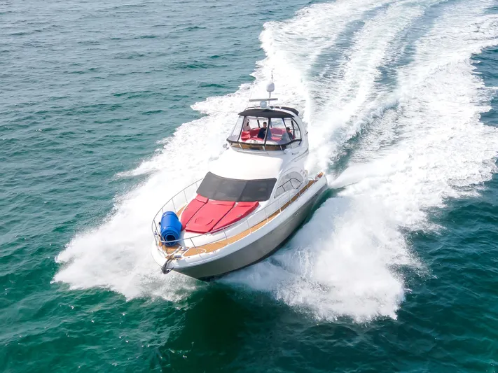  Yacht Photos Pics 2006 Sea Ray 44 Sedan Bridge cruising on open water, creating a wake.