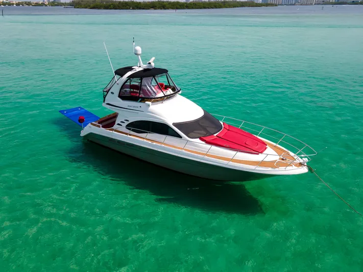  Yacht Photos Pics 2006 Sea Ray 44 Sedan Bridge yacht on turquoise water.