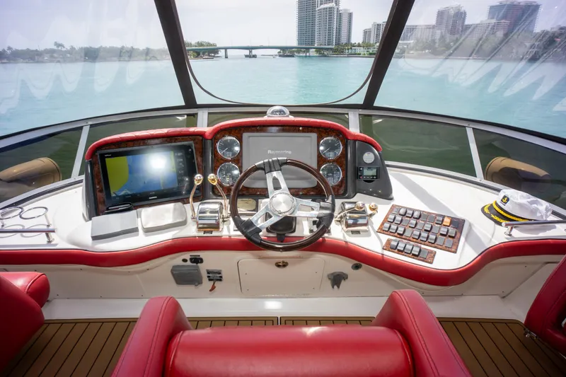  Yacht Photos Pics Helm of 2006 Sea Ray 44 Sedan Bridge with red seating and modern navigation equipment.