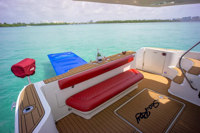  Yacht Photos Pics 2006 Sea Ray 44 Sedan Bridge yacht deck with red seating and ocean view.