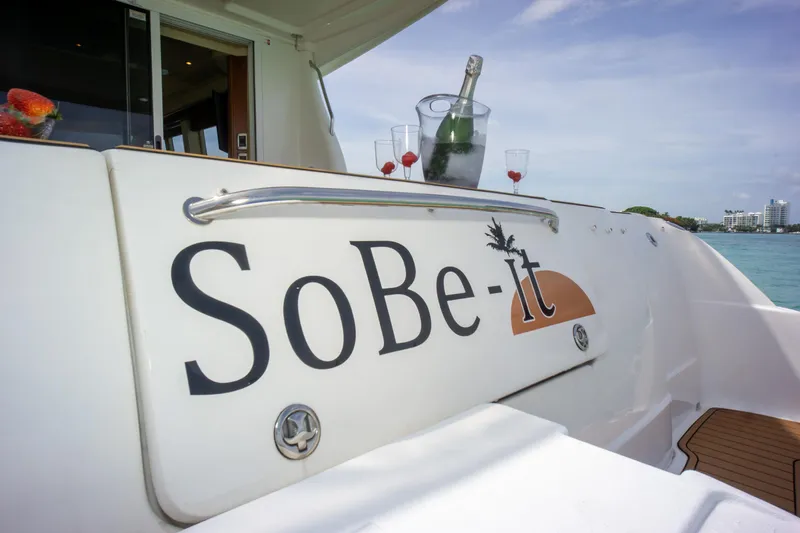  Yacht Photos Pics 2006 Sea Ray 44 Sedan Bridge yacht with "SoBe-It" name, champagne, and glasses on deck.