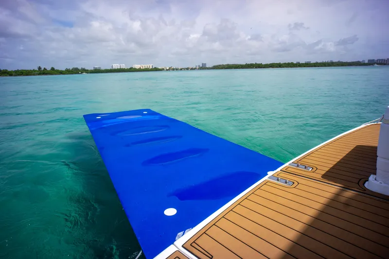  Yacht Photos Pics 2006 Sea Ray 44 Sedan Bridge with blue swim platform on turquoise water.