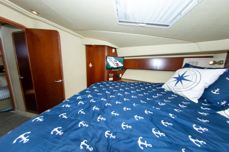  Yacht Photos Pics Luxurious cabin interior of 2006 Sea Ray 44 Sedan Bridge with nautical-themed bedding.