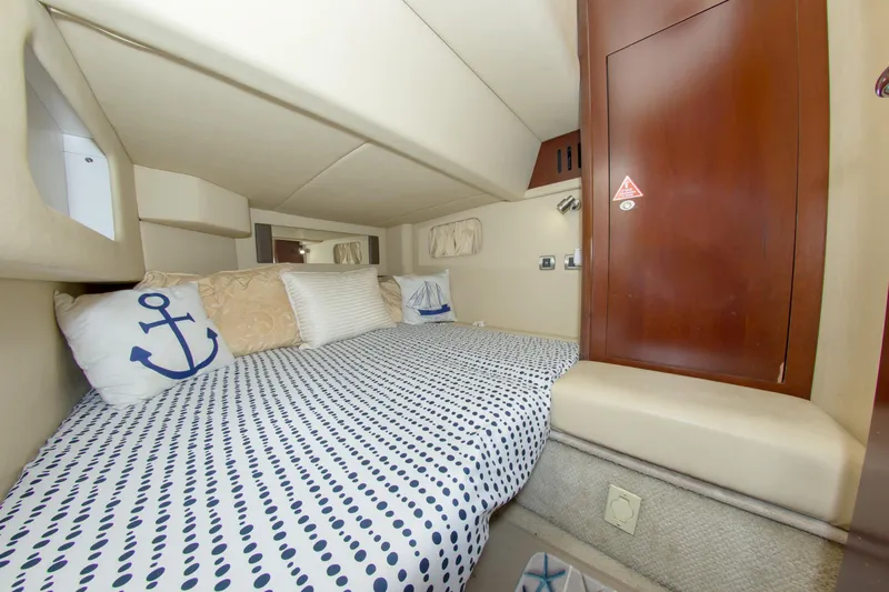  Yacht Photos Pics 2006 Sea Ray 44 Sedan Bridge cabin with polka dot bedding and anchor-themed pillows.