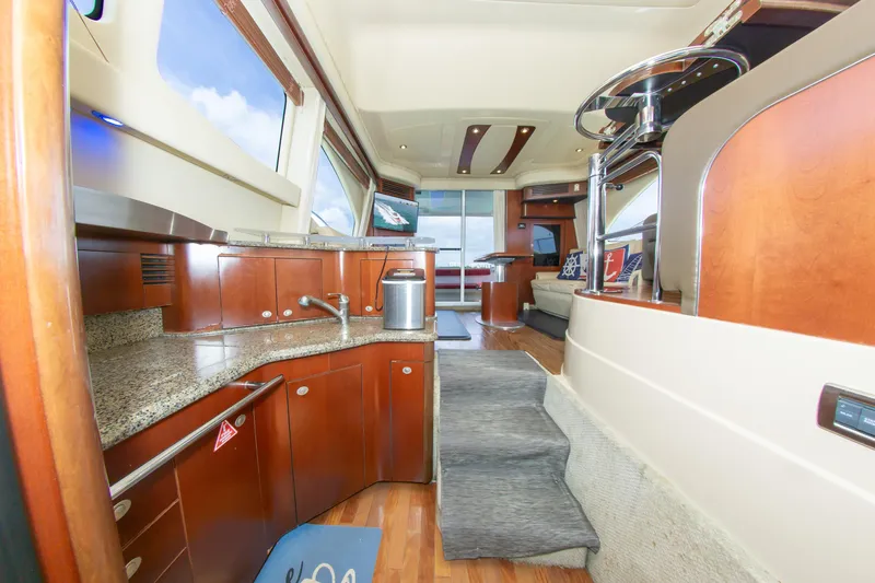 Yacht Photos Pics Interior of 2006 Sea Ray 44 Sedan Bridge yacht with modern kitchen and seating area.