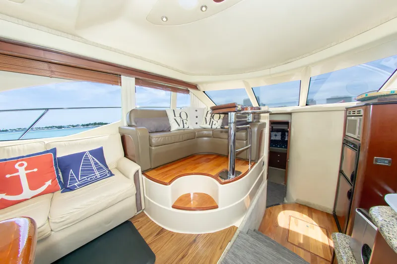  Yacht Photos Pics Luxurious interior of 2006 Sea Ray 44 Sedan Bridge yacht with elegant seating and panoramic windows.