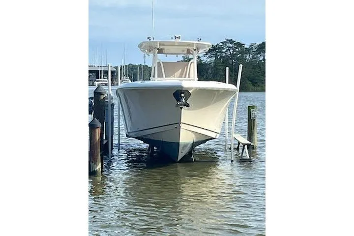  Yacht Photos Pics 2017 Sailfish 320 CC boat docked on calm water, front view.