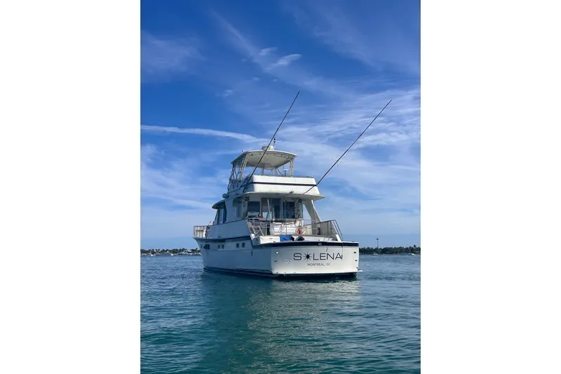 Masterplan Yacht Photos Pics 1975 Hatteras 58 Yacht Fisherman on calm water under clear blue sky.