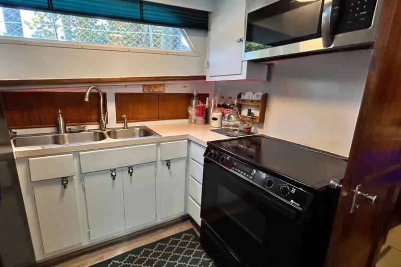 Masterplan Yacht Photos Pics 1975 Hatteras 58 YF yacht kitchen with modern appliances and dual sink.