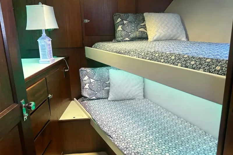 Masterplan Yacht Photos Pics Cozy cabin interior of 1975 Hatteras 58 YF with bunk beds and nautical decor.