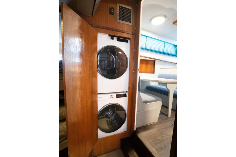 Masterplan Yacht Photos Pics Stacked washer and dryer in 1975 Hatteras 58 YF yacht interior.