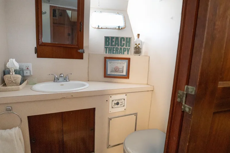 Masterplan Yacht Photos Pics Bathroom interior of 1975 Hatteras 58 YF yacht with sink and decor.