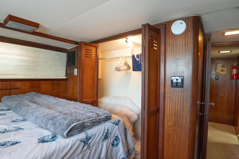 Masterplan Yacht Photos Pics 1975 Hatteras 58 YF yacht bedroom with wooden closet and cozy bedding.