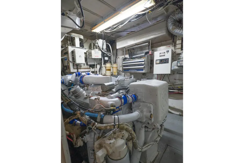 Masterplan Yacht Photos Pics Engine room of a 1975 Hatteras 58 YF yacht, showcasing mechanical components and wiring.