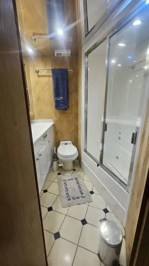  Yacht Photos Pics Bathroom interior of 1999 Hatteras 65 Convertible yacht with shower and toilet.