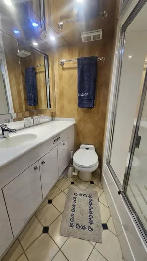  Yacht Photos Pics Bathroom interior of 1999 Hatteras 65 Convertible yacht, featuring modern fixtures and elegant design.