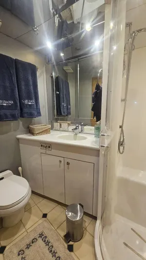  Yacht Photos Pics Bathroom interior of a 1999 Hatteras 65 Convertible yacht with shower and vanity.