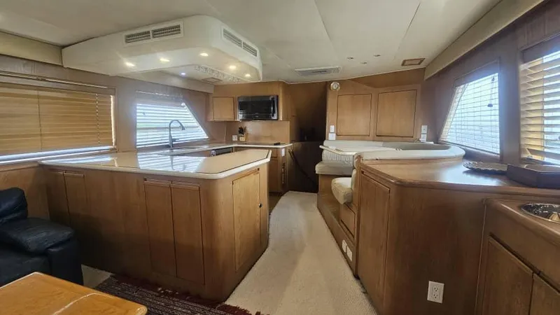  Yacht Photos Pics Interior of 1999 Hatteras 65 Convertible yacht with wood cabinetry and modern amenities.