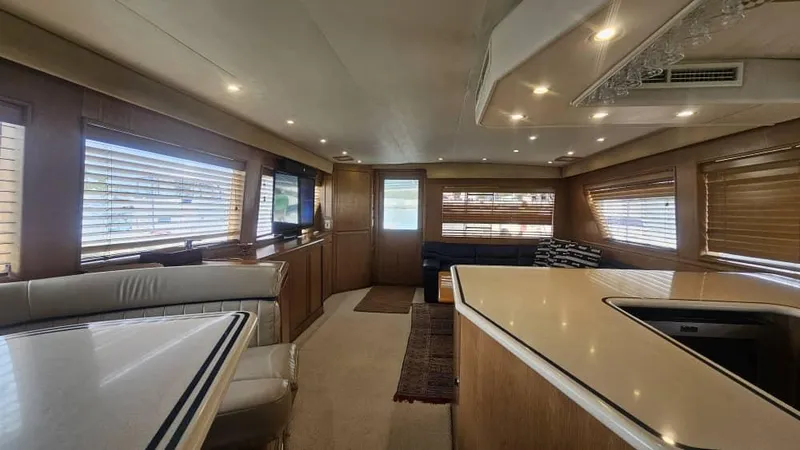  Yacht Photos Pics Luxurious interior of a 1999 Hatteras 65 Convertible yacht with modern furnishings.