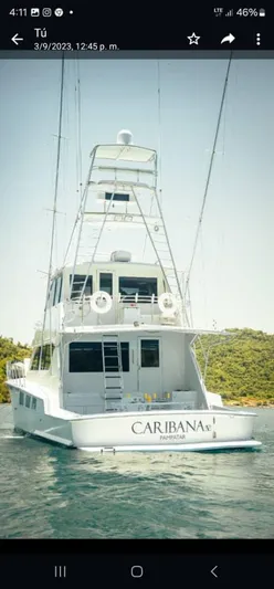  Yacht Photos Pics 1999 Hatteras 65 Convertible yacht on water, rear view, with fishing tower.